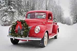 Wonderland Prints: Man driving a vintage 1941 Ford pickup with a Christmas wreath on the front during Winter in Southcentral