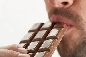 25 To 30 Years Prints: Man Eating Chocolate Bar