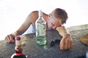 30 To 35 Years Prints: Man falling asleep drunk at a bar counter