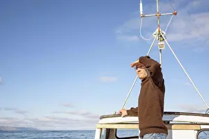 Pensive Prints: Man on fishing boat in sea