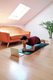 Active Wear Prints: Man following exercise class on laptop