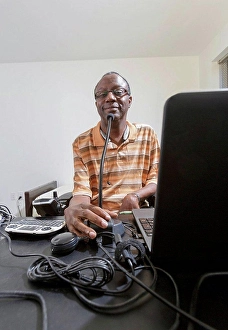 Boston Prints: Man with Guillain-Barre Syndrome using his technical equipment at home office