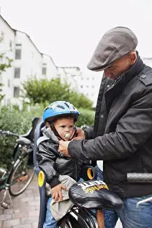 Bicycle Prints: Man helsping son with helmet