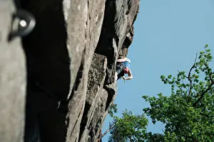 Stockholm Prints: man high up on a rock face climbing outdoors in Sweden