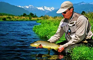 Somebody Prints: Man holding brown trout, Spring Creek, South Island, New Zealand