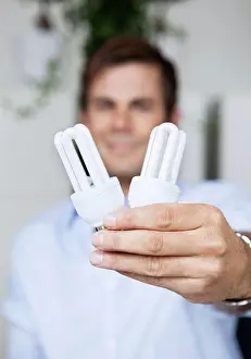 Shirts Prints: Man holding low-energi bulb