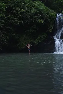 Jump Prints: Man jumps from a cliff into the Alin-Alin waterfall. Bali