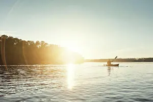 Paddle Prints: Man, kayaking and boat on lake outdoor for sports adventure or nature travel trip
