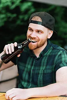 Beverage Prints: Man opening beer bottle cap with his teeth