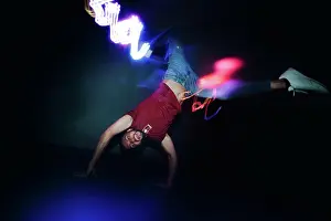 Agility Prints: Man performing dance in spotlights