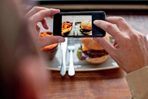 Consumer Electronics Prints: Man photographing food with smartphone