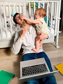 Notebook Prints: Man playing with his daughter wile working at home on selfisolation