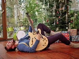 Red Letter Day Prints: Man playing electric guitar in front of Christmas tree