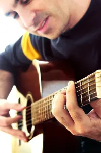 Fingers Prints: Man playing a musical instrument accoustic guitar