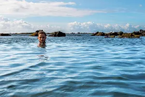 Refreshing Prints: A man relaxing in a tidal pool on the south coast of the Big Island of Hawaii (MR)