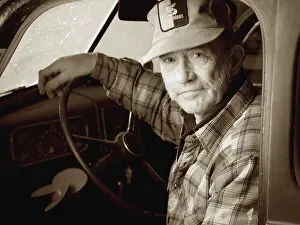 Wisdom Prints: A man sits in the front seat of his 1937 Chevy( black and white toned image)