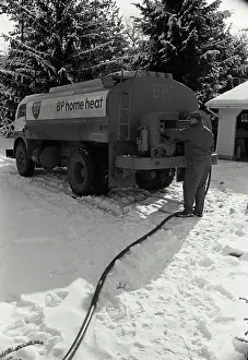 Unrecognisable Prints: Man standing near a fuel tanker