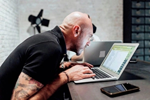 Upper Body Prints: Man using laptop, peering