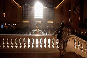 Circus Prints: A man wearing a camouflage military uniform looks out over the concourse in Grand Central station