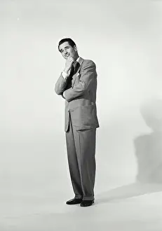 Contemplating Prints: Man in zoot suit on white background with hand on chin