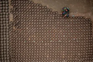 Forms Prints: Manikgonj, Bangladesh - 20 February 2022: Aerial view of a woman working with clay pot in Manikgonj