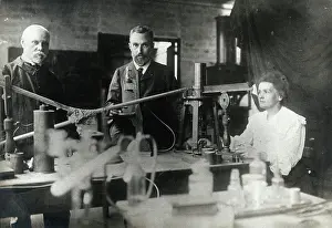 Pierre Prints: Marie and Pierre Curie (centre) with a man