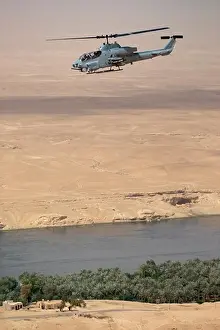 Middle East Prints: A US Marine Corps AH-1W Super Cobra Flies Above the Euphrates River During a Close Air Support Mission in Iraq's Al