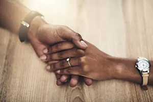 Kindness Prints: Marriage, support and people with holding hands on table for partnership