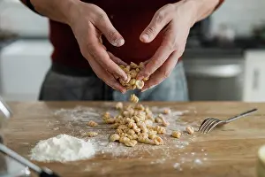 Flour Prints: Masculine hands tossing and sprinkling flour on homemade pasta