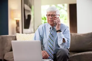 Dialogue Prints: Mature Caucasian Male doctor practicing tele-medicine from his home