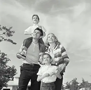 Mature Women Prints: Mature couple with their children looking up