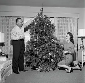Mature Women Prints: Mature couple decorating Christmas tree