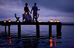 50 To 55 Years Prints: Mature couple enjoying their date on the pier at twilight