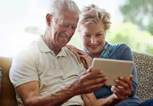 Download Prints: Mature couple, lounge and streaming with tablet