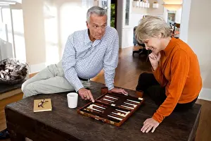 Model Release Prints: Mature couple playing backgammon