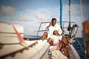 Conversation Prints: Mature couple relaxing together on boat deck in the sunshine
