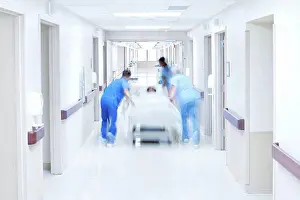 Corridor Prints: Medical team pushing patient on bed