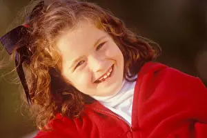 Freckles Prints: Medium close up of a cute young girl with freckles looking at the camera and smiling