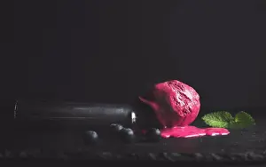 Back Ground Prints: Melting blueberry ice-cream scoop over black slate stone background