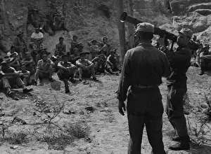 1950 Prints: Men of 3 Bn Royal Australian Regiment display keen interest in the demonstration of the 3