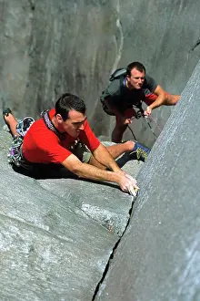 Tenacity Prints: Two men rock climbing on a large granite face in North Carolina