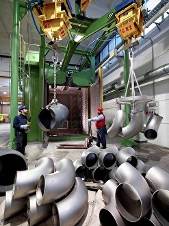 Manual Worker Prints: Men working in a steel factory, lifting u-bend tubes on winches