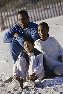 Sideways Prints: Mid adult couple on the beach with their son