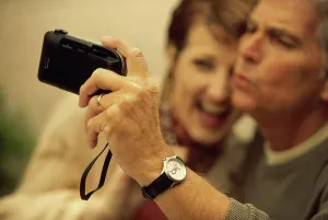 Wristwatch Prints: Mid adult couple taking a photograph of themselves