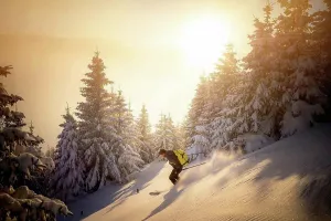 Winter Clothes Prints: Mid adult man skiing on snowy mountain during sunrise