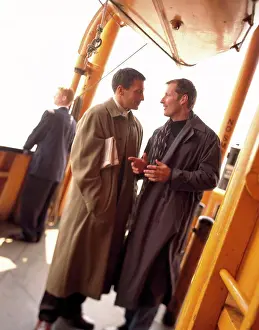 Ship Prints: Two mid adult men having a discussion on the deck of a ferry