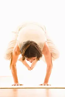 Only Adults Prints: Mid adult woman practising yoga (Crane Pose), yoga studio at Linz, Austria