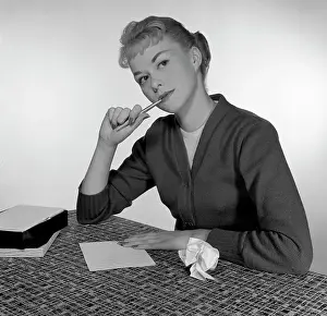 Contemplating Prints: Mid adult woman writing letter