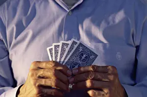Cards Prints: Mid section view of a man holding playing cards