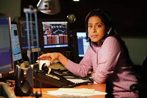 Sorrow Prints: Middle aged businesswoman posing for the camera at her desk